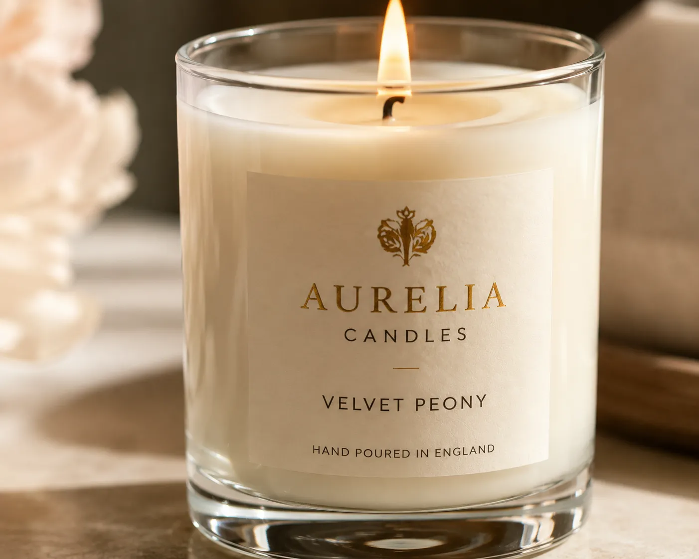Hands pouring wax into a small-batch candle in an artisan candle studio