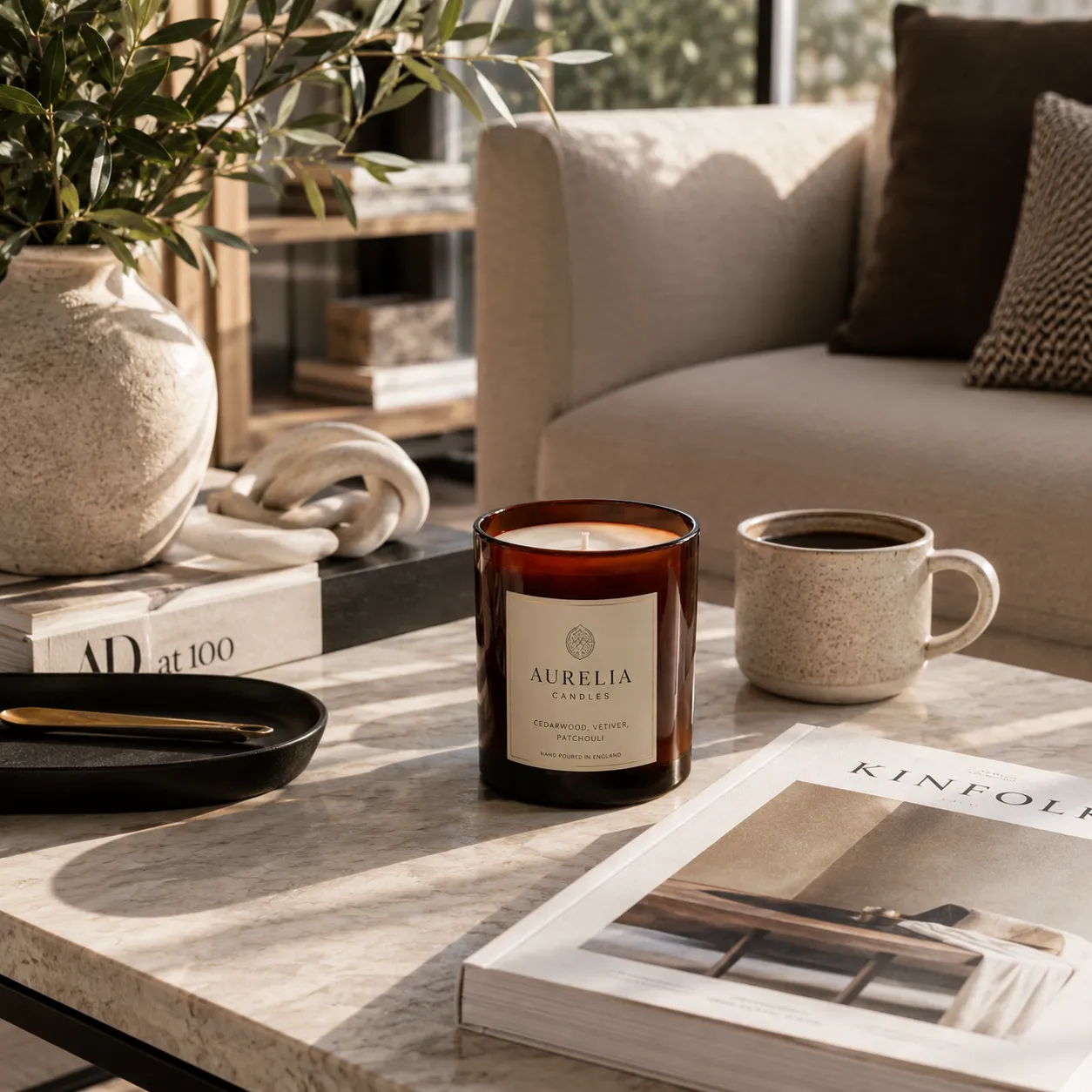 A warm scented candle transforming the mood of a softly lit living room at dusk